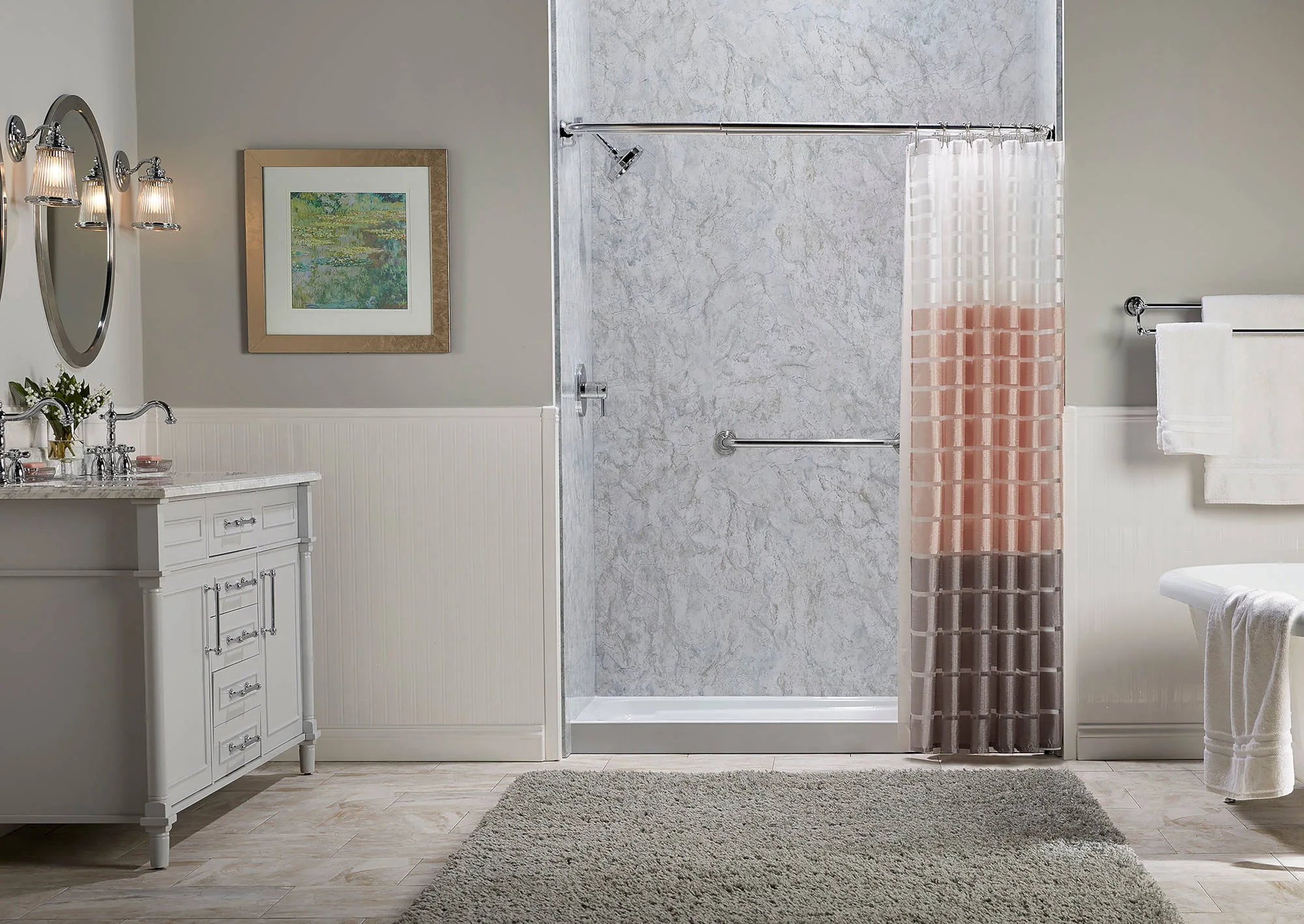 A bathroom with a walk-in shower featuring grab bars and shower curtain.