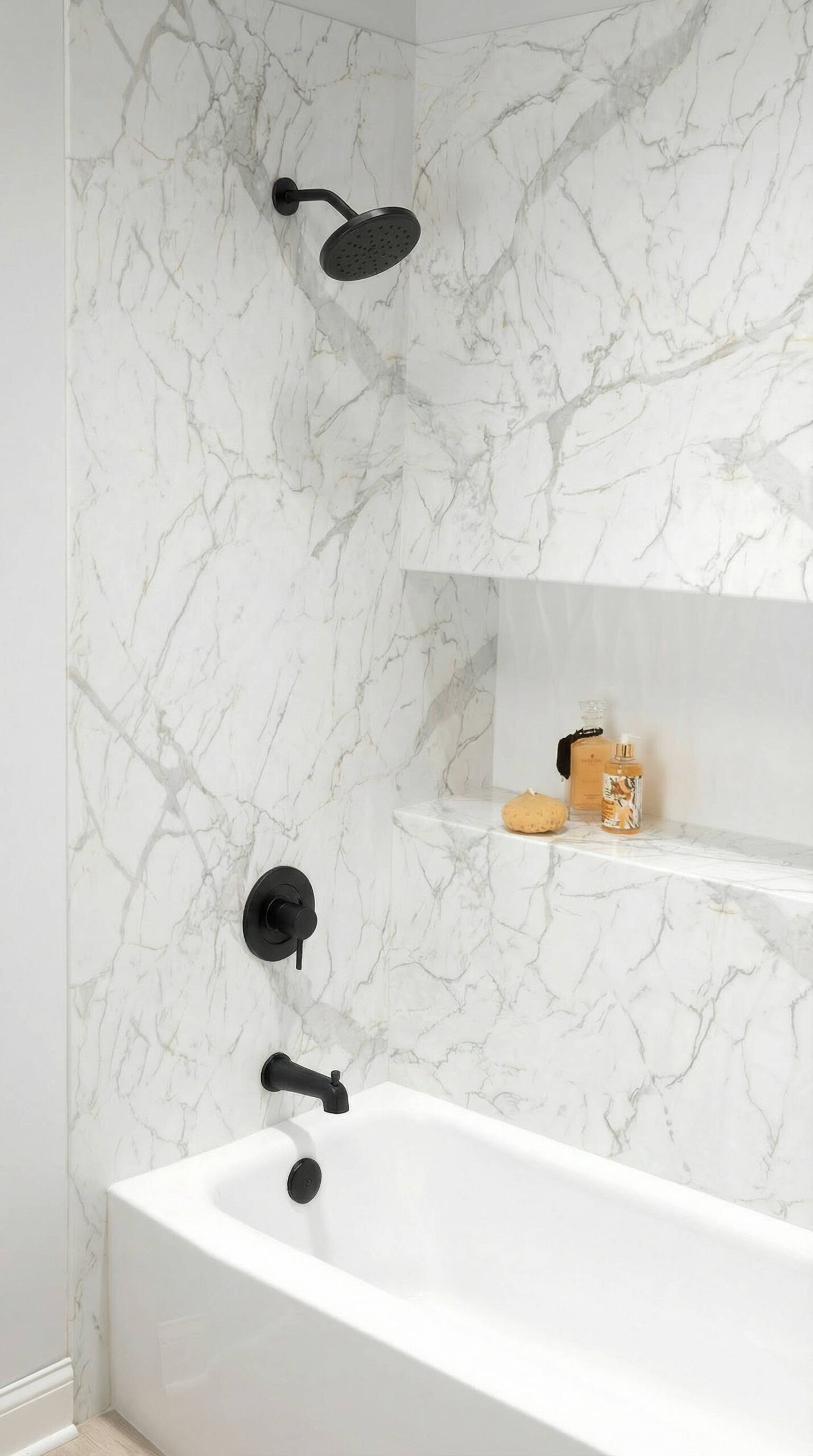 Marble walk-in shower wall with built-in shelf niche