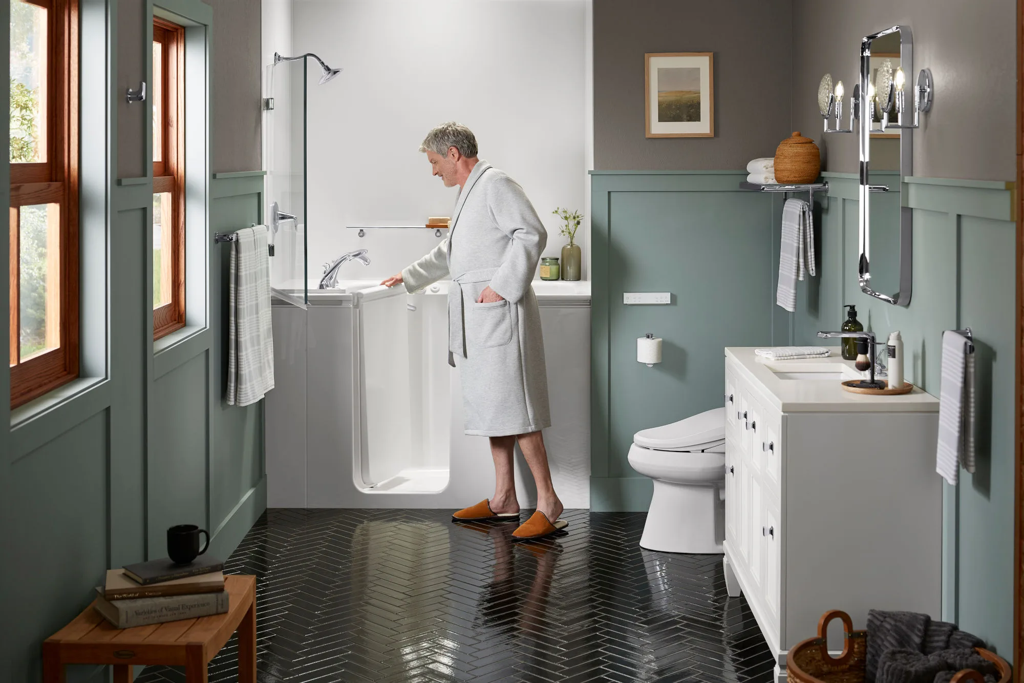 Older man in bath rob closing the door on a walk-in bathtub.
