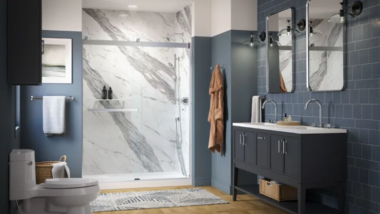 A blue tiled bathroom with a double vanity sink and walk-in shower.