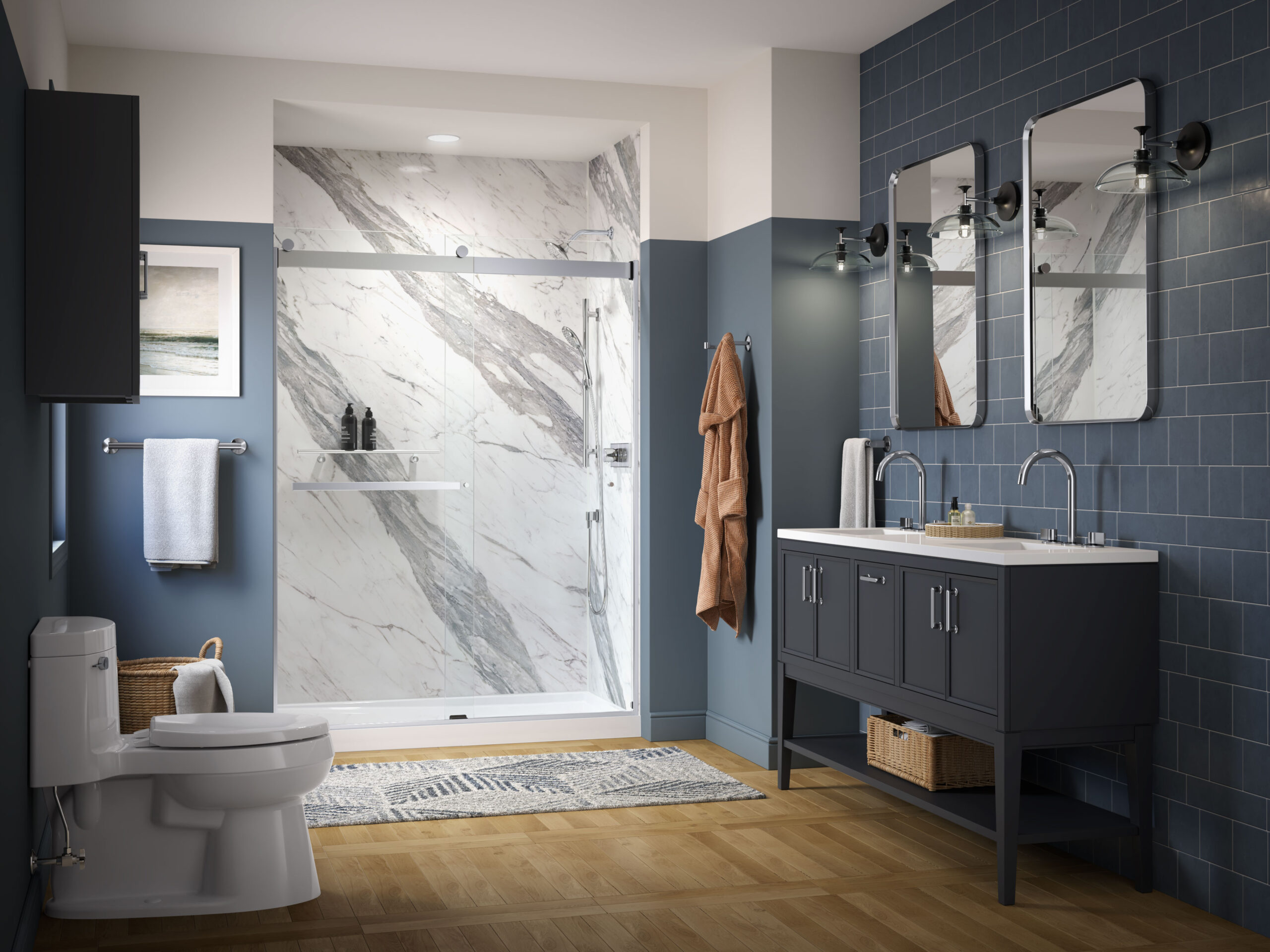 Walk-in shower with marble-look wall panels and sliding glass door in a bathroom with double sink vanity