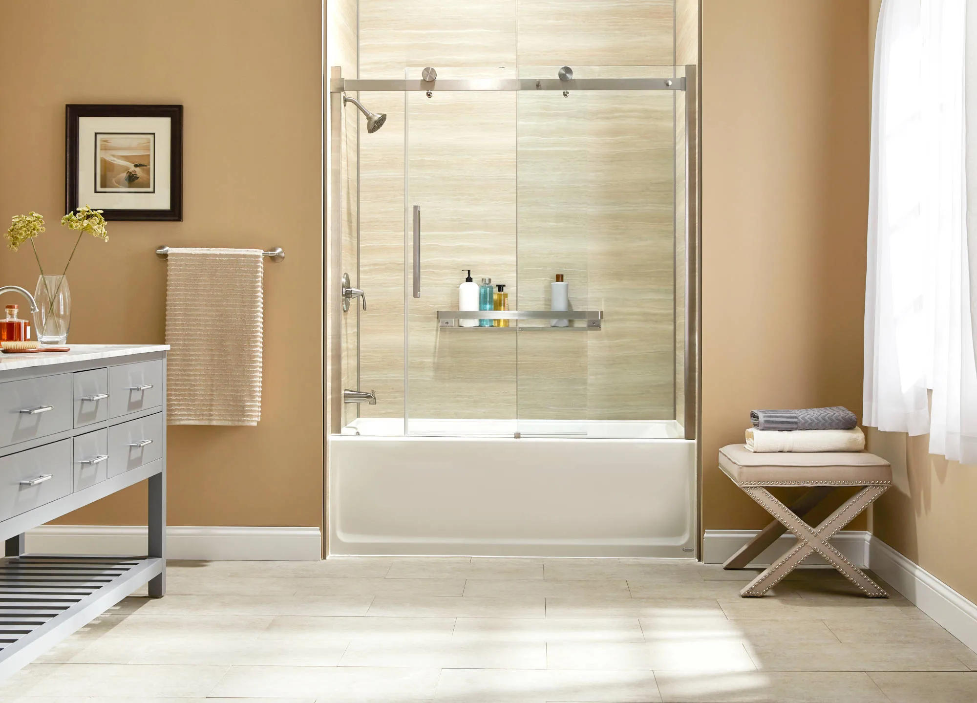 Walk-in shower with glass enclosure and tile walls