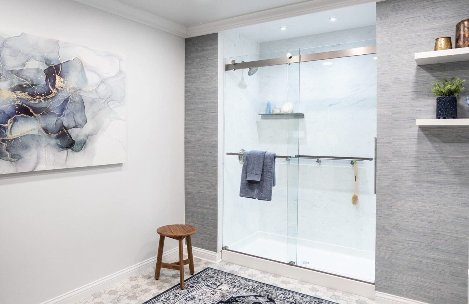 Modern bathroom with frameless glass shower, sliding door, and tiled walls.