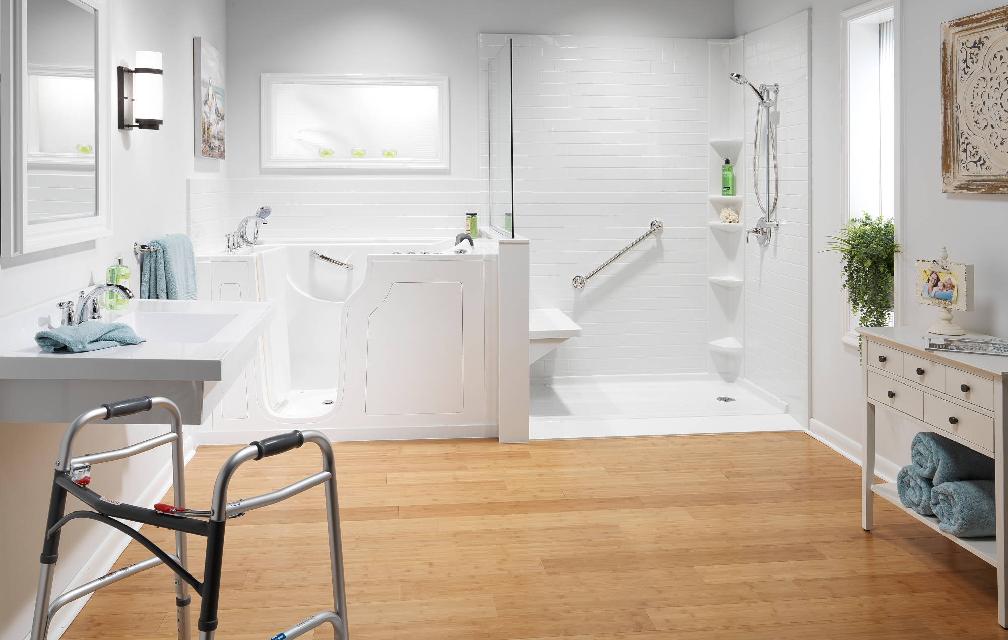 Accessible white bathroom with walk-in shower, grab bars, and walker
