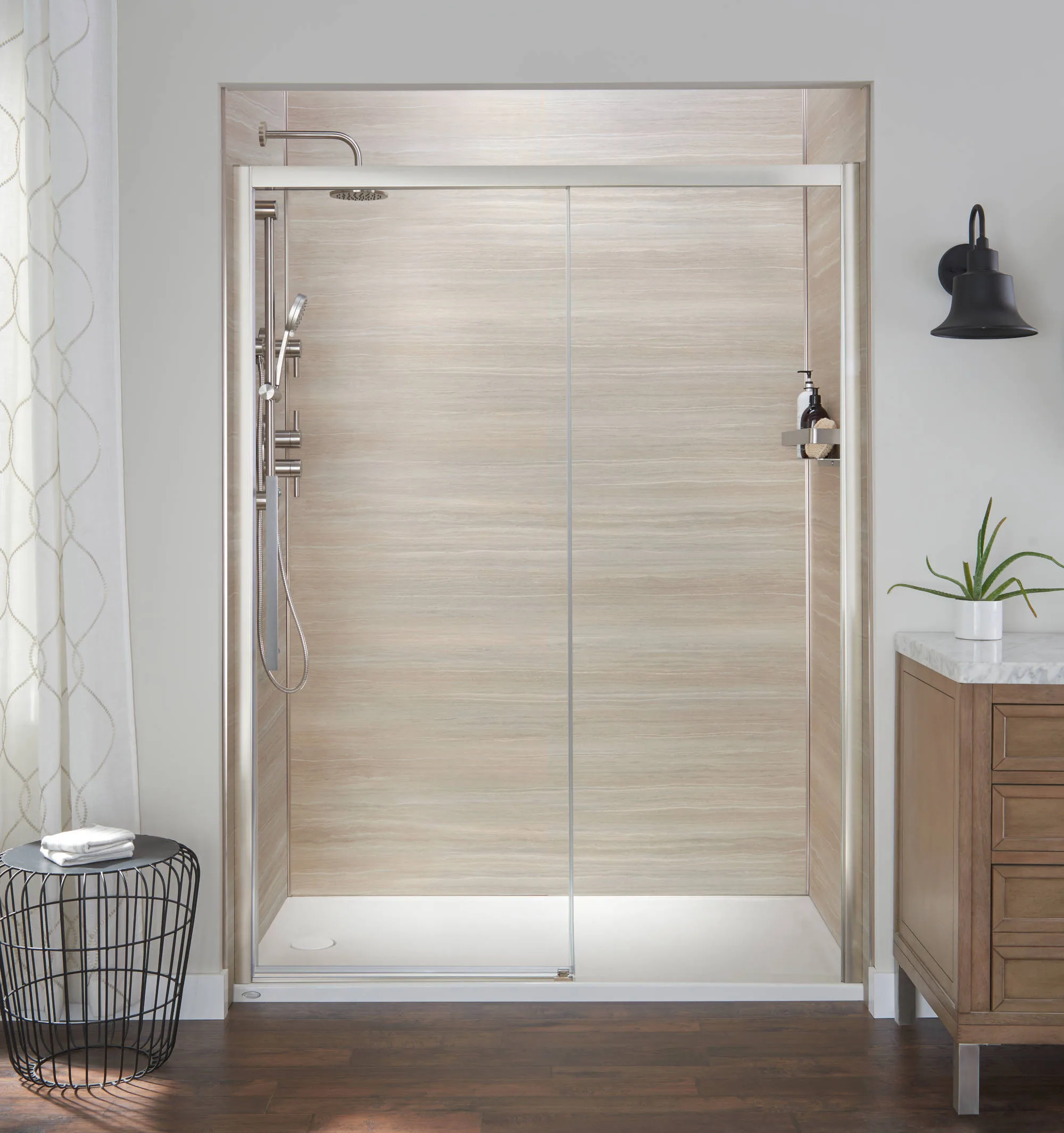 Frameless sliding glass shower door with light wood-look wall panels