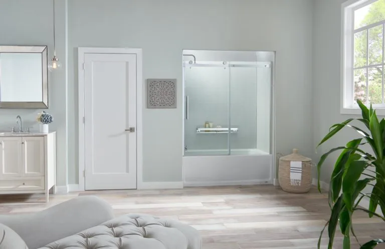 Light blue bathroom with glass shower enclosure and white vanity